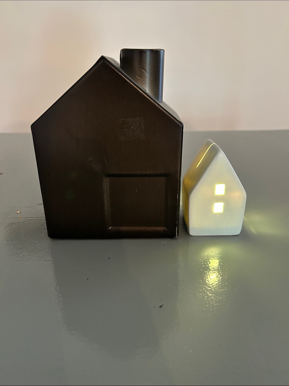 Two Farmhouse Decor houses- brown metal and light blue ceramic